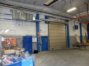 En ovanblåsande luftridå från RMK på industriport med blå dörr.